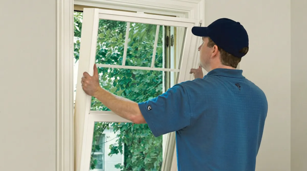 Professional contractors performing a residential window insulation and replacement service in South Bend, IN